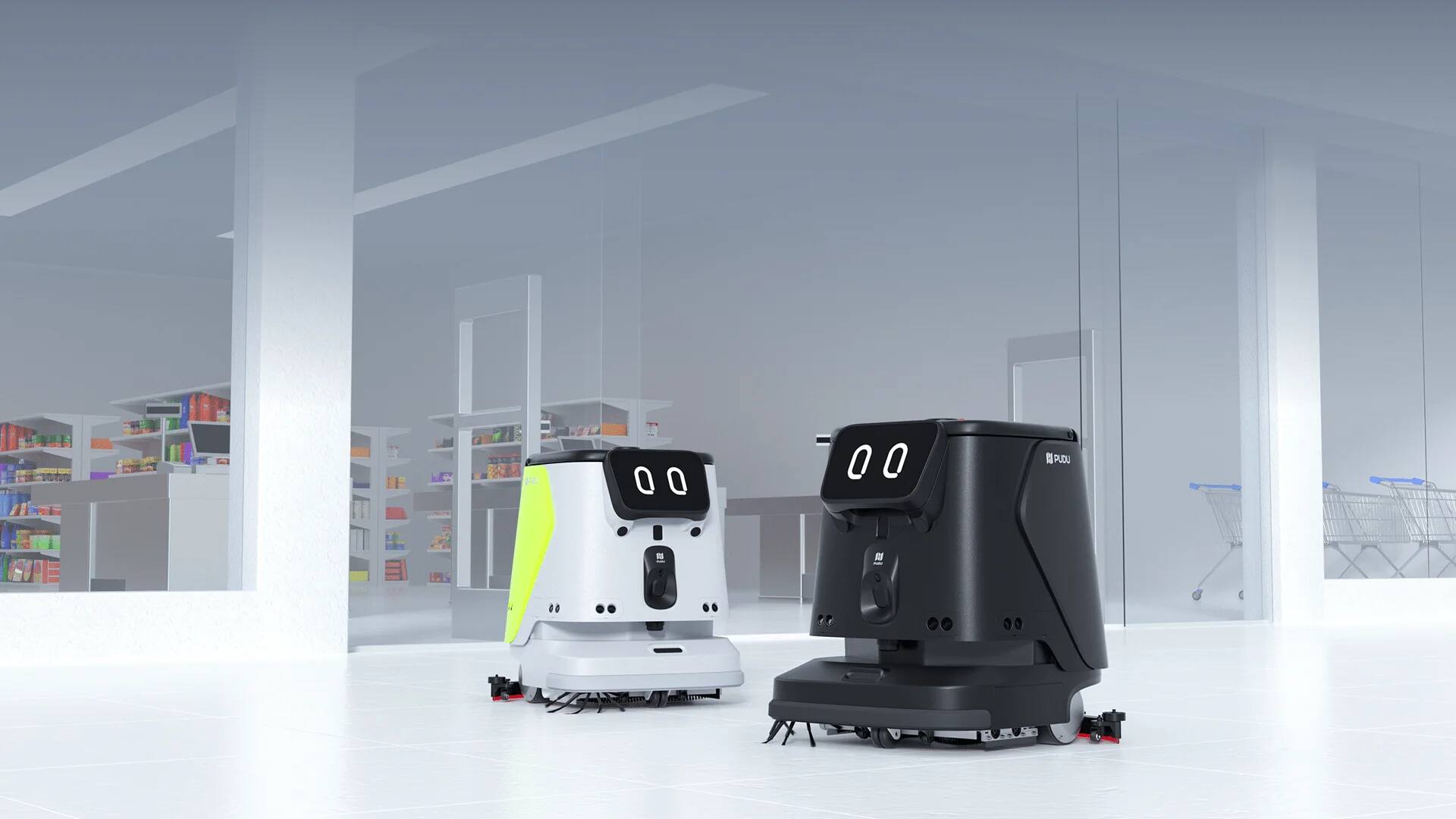 Deux autolaveuses autonomes PUDU CC1 Pro, l’une blanche et l’autre noire, à l’arrêt sur le sol clair d’une surface de vente.