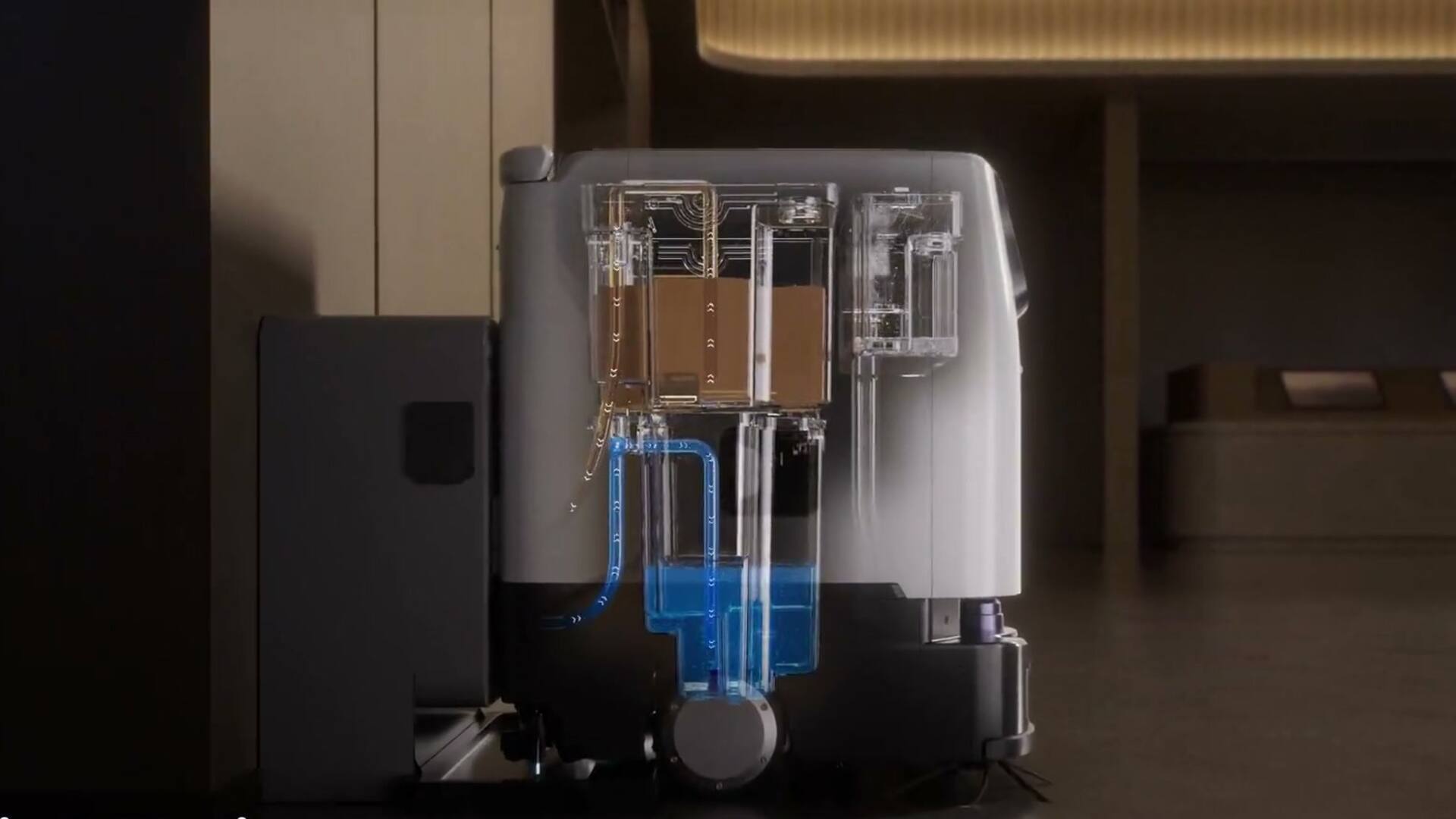 Vue en coupe d’un robot PUDU ET1 amarré à sa station, circuits d’eau propre et d’eau sale apparents.